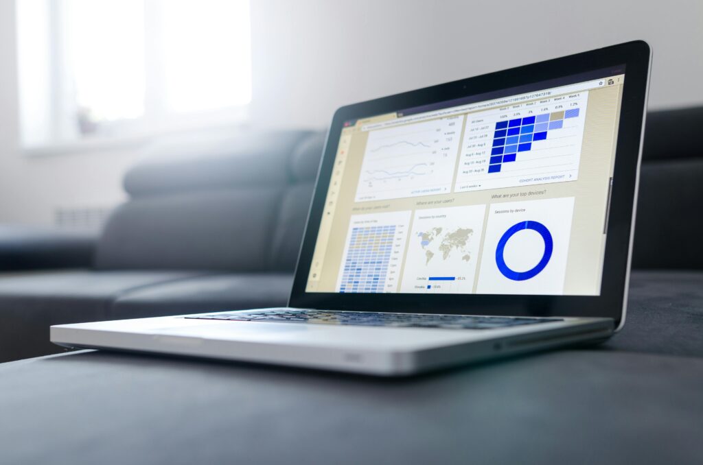 pexels-photo-577210-577210 Sleek laptop showcasing data analytics and graphs on the screen in a bright room.